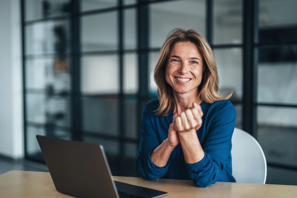 A small business owner confidently working at her laptop